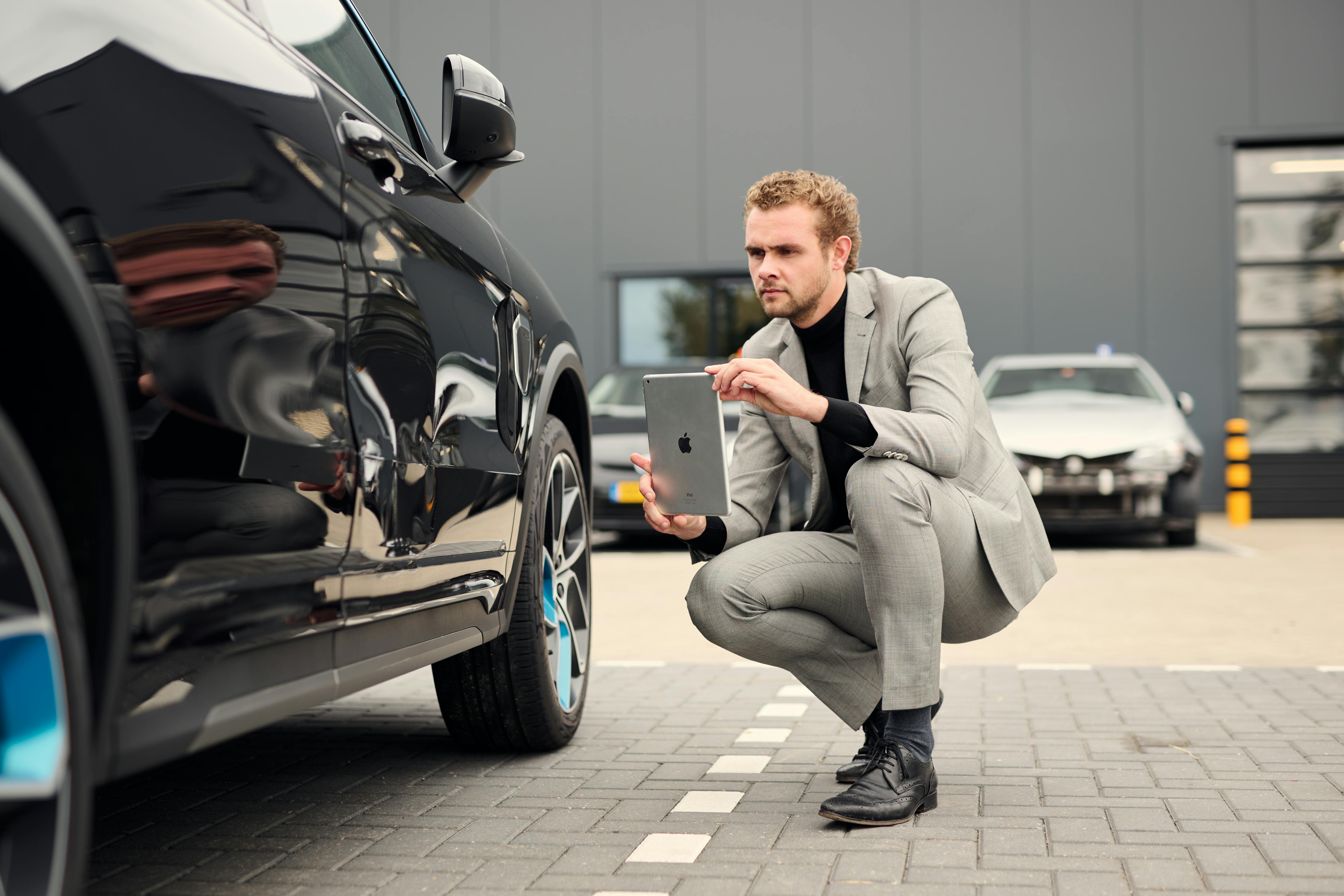 Fleet manager taking photos of a damaged vehicle